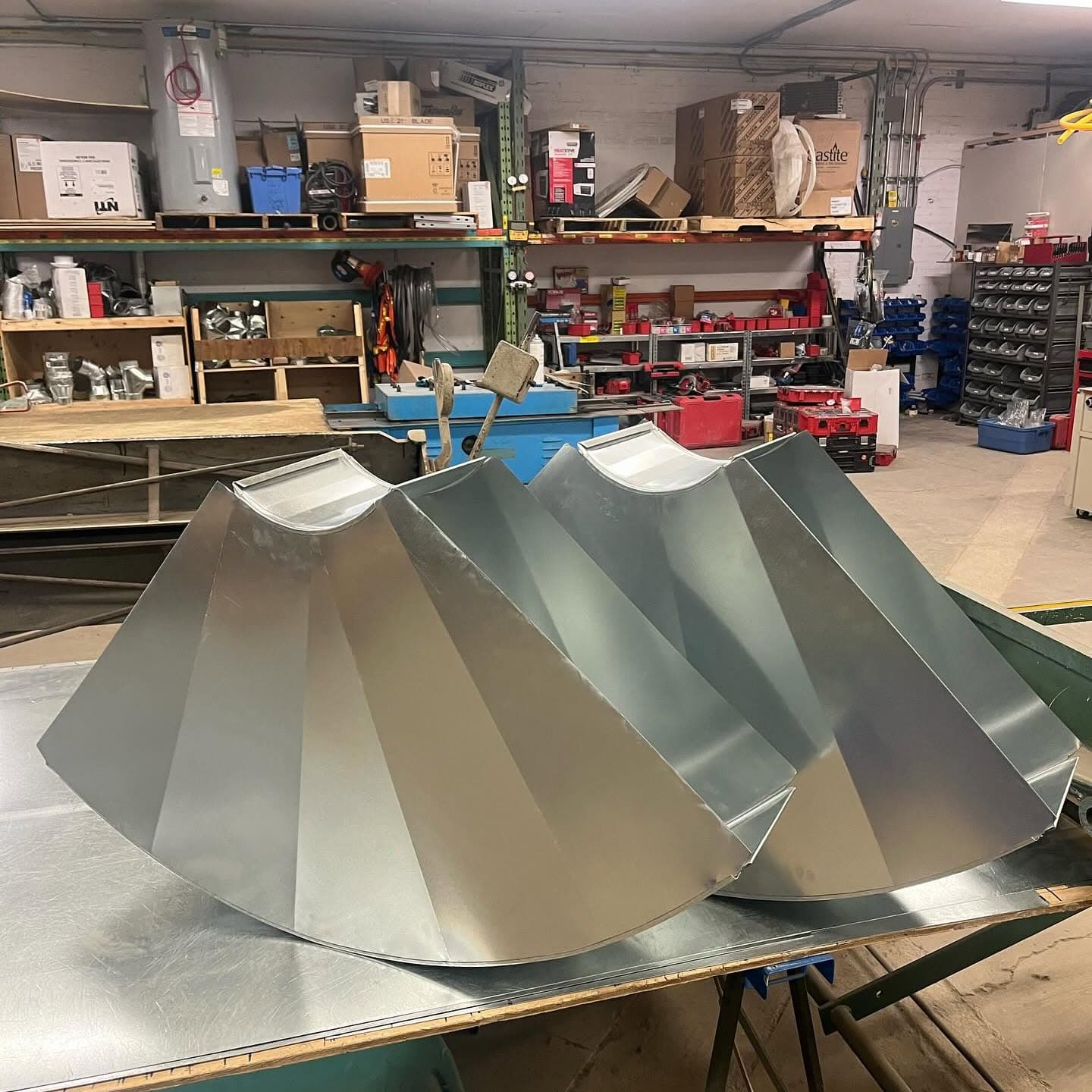 Large galvanized duct elbows waiting for pickup
