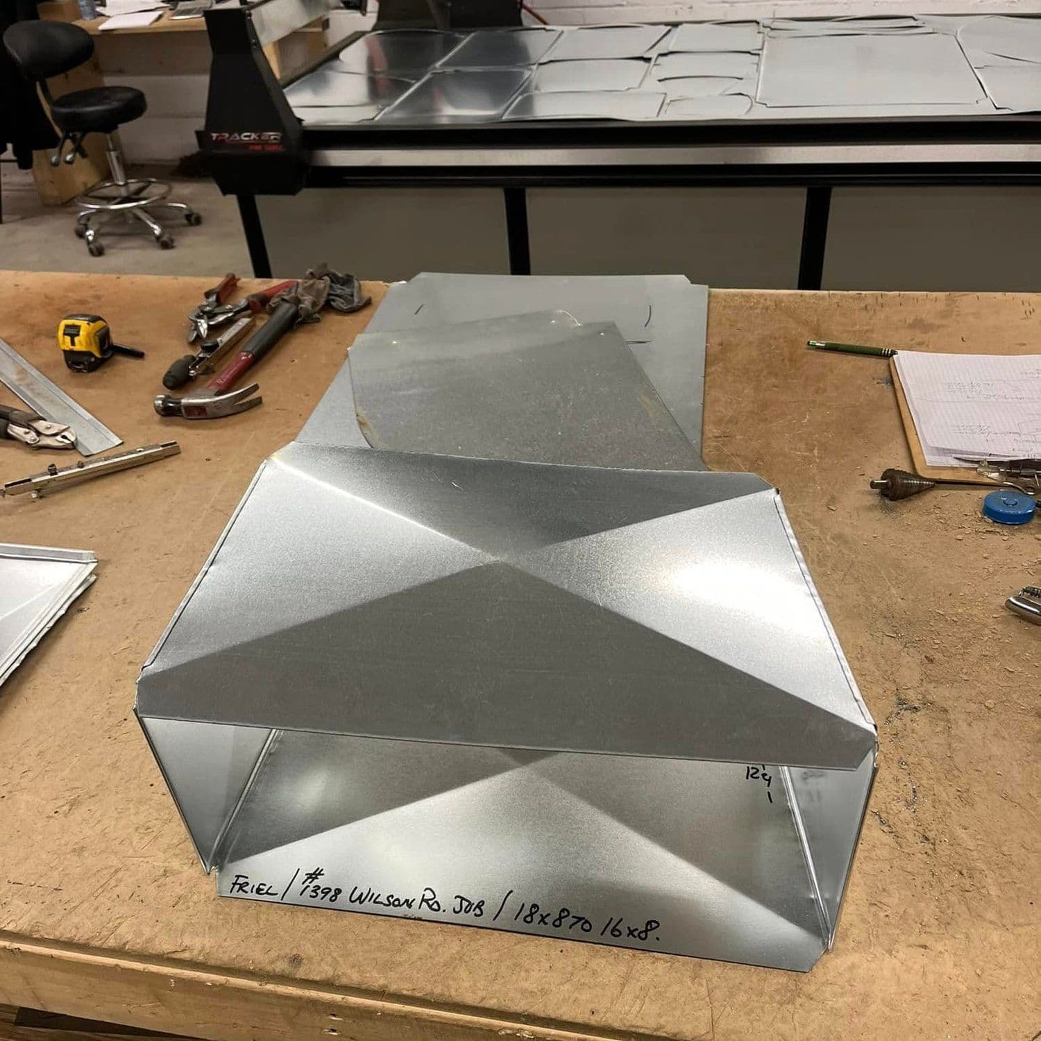 A finished fitting with the job written on it in marker