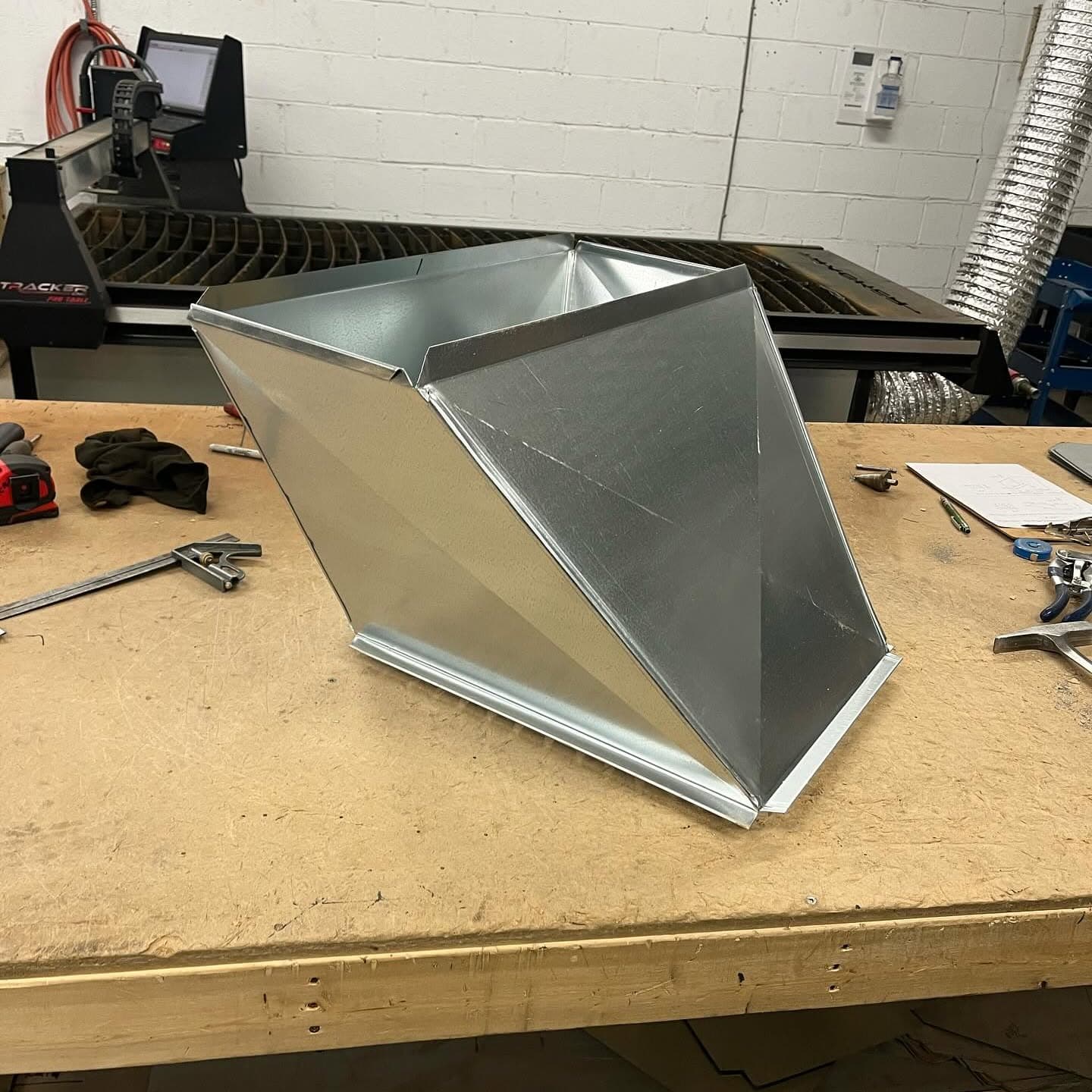 A galvanized duct offset on the bench