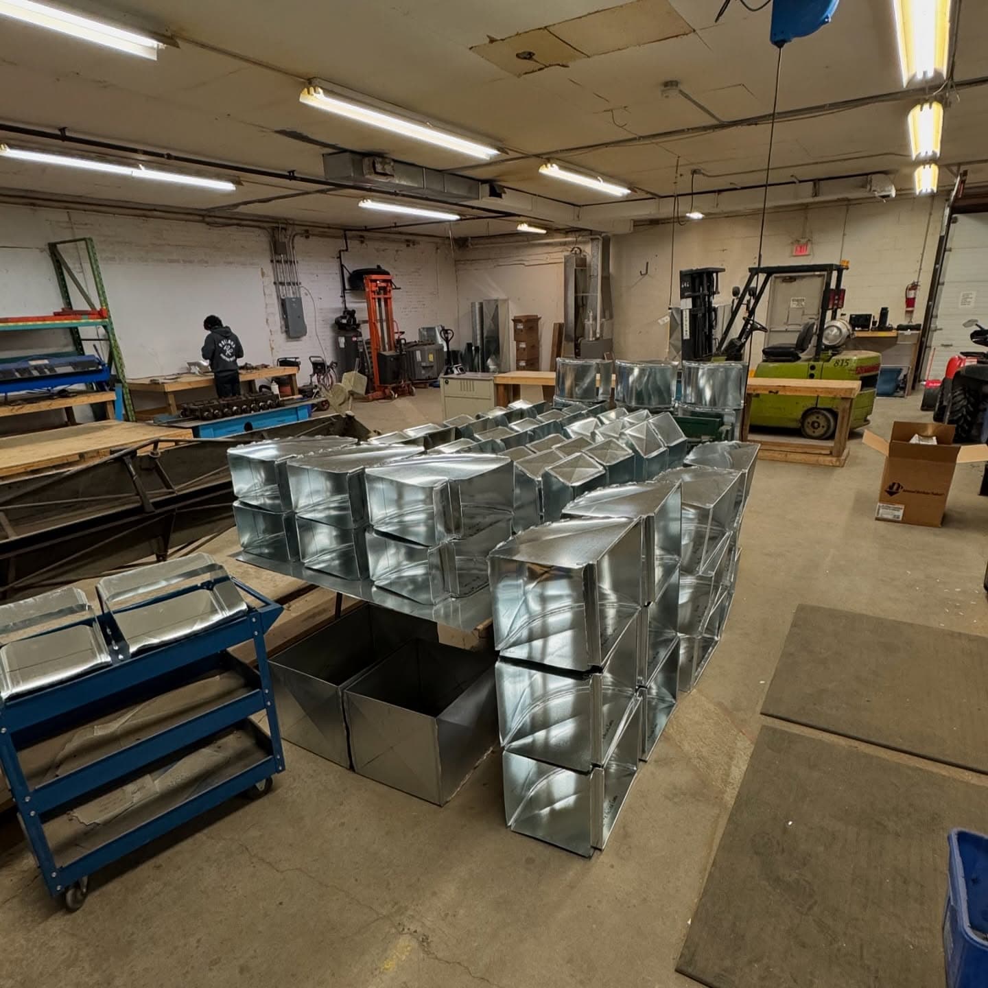 Stacks of finished fittings on a cart in the shop